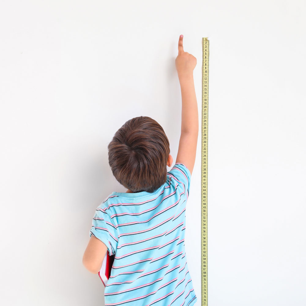 Child measuring the wall