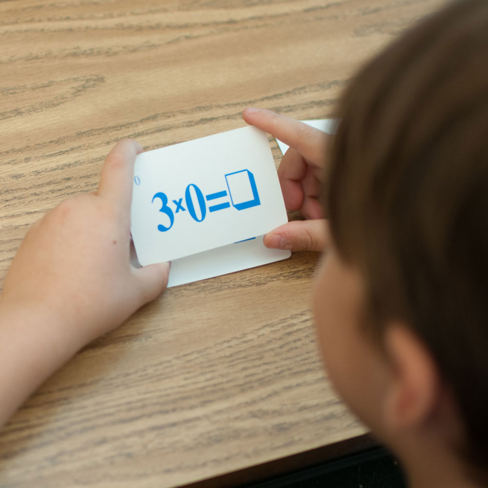 Student with multiplication fact flash cards