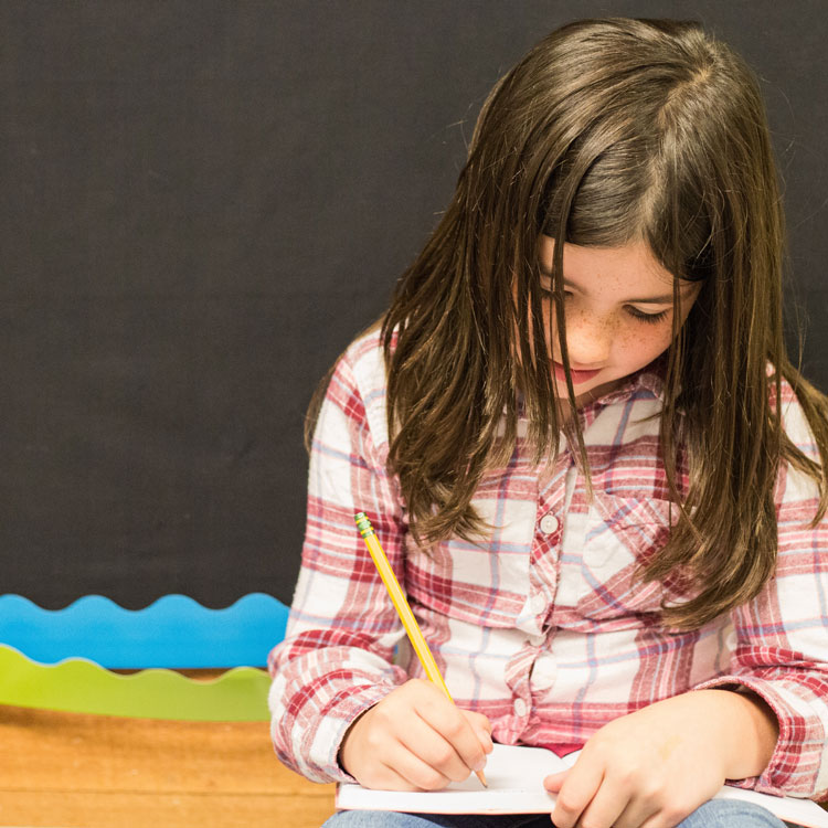 Student writing in notebook