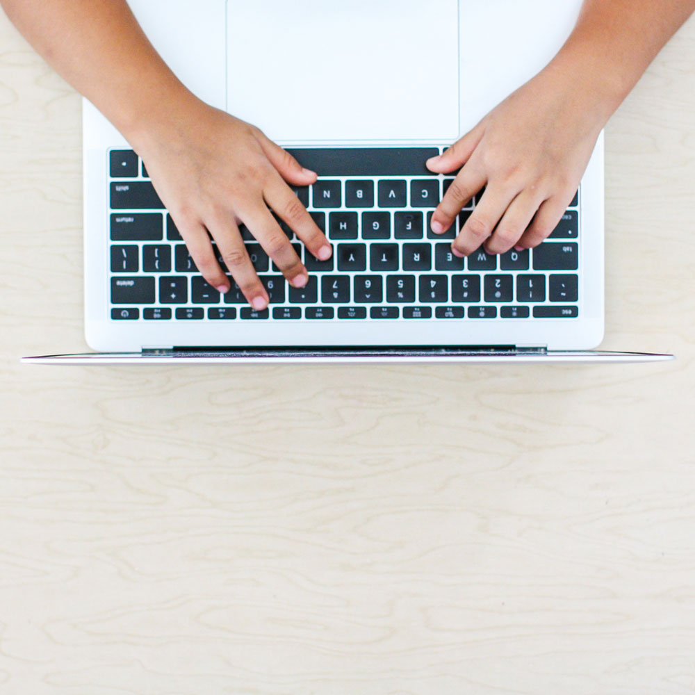 Student typing on laptop