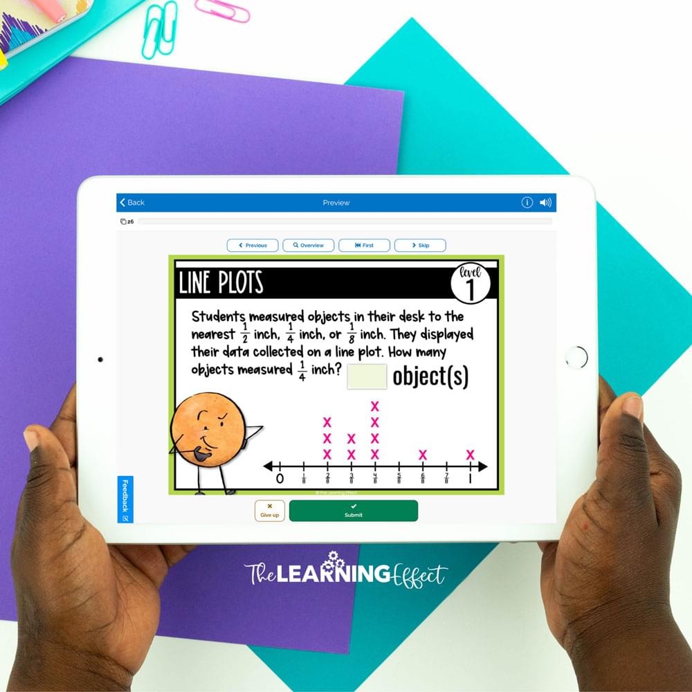 Student holding ipad with boom card activity